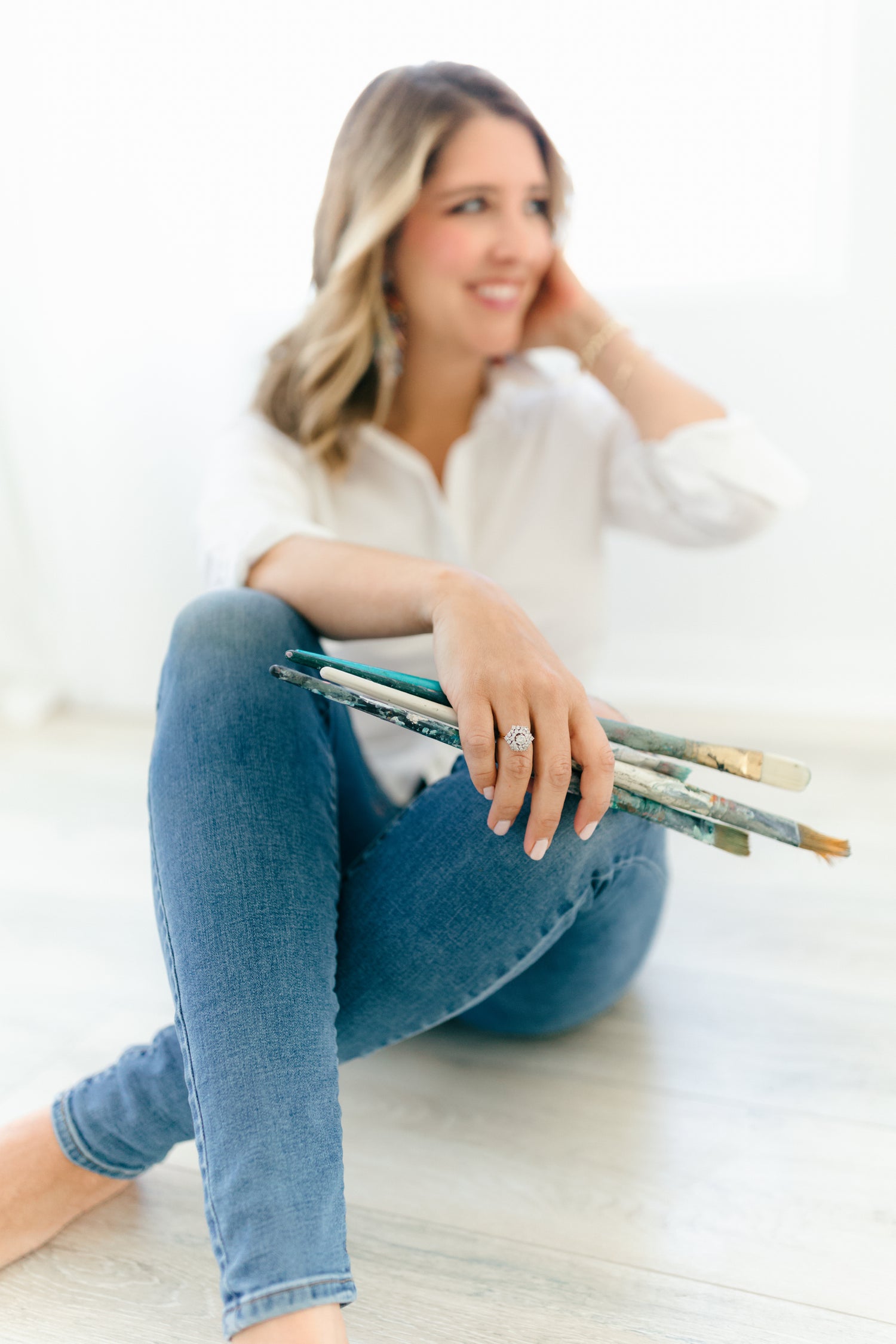 Candace holding paintbrushes
