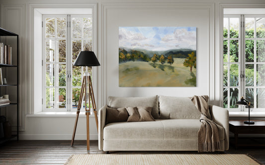 Living room with landscape painting and sofa.