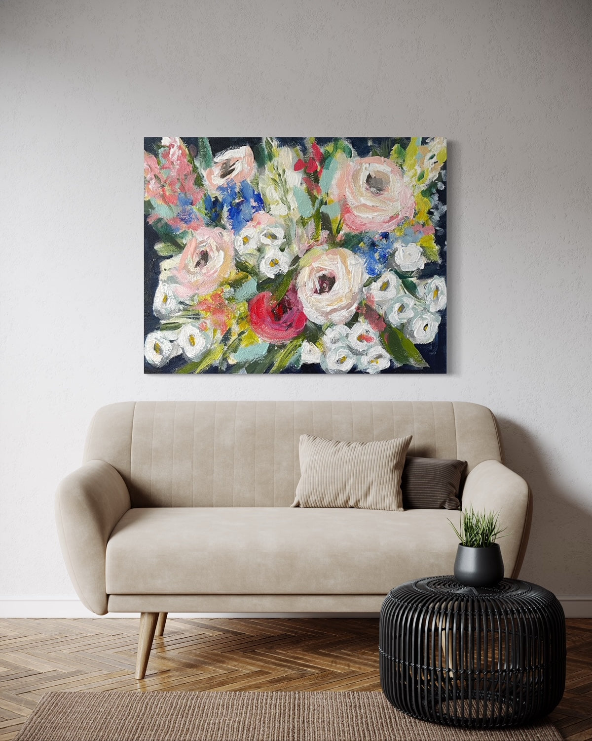 Painting of flowers above a beige couch.