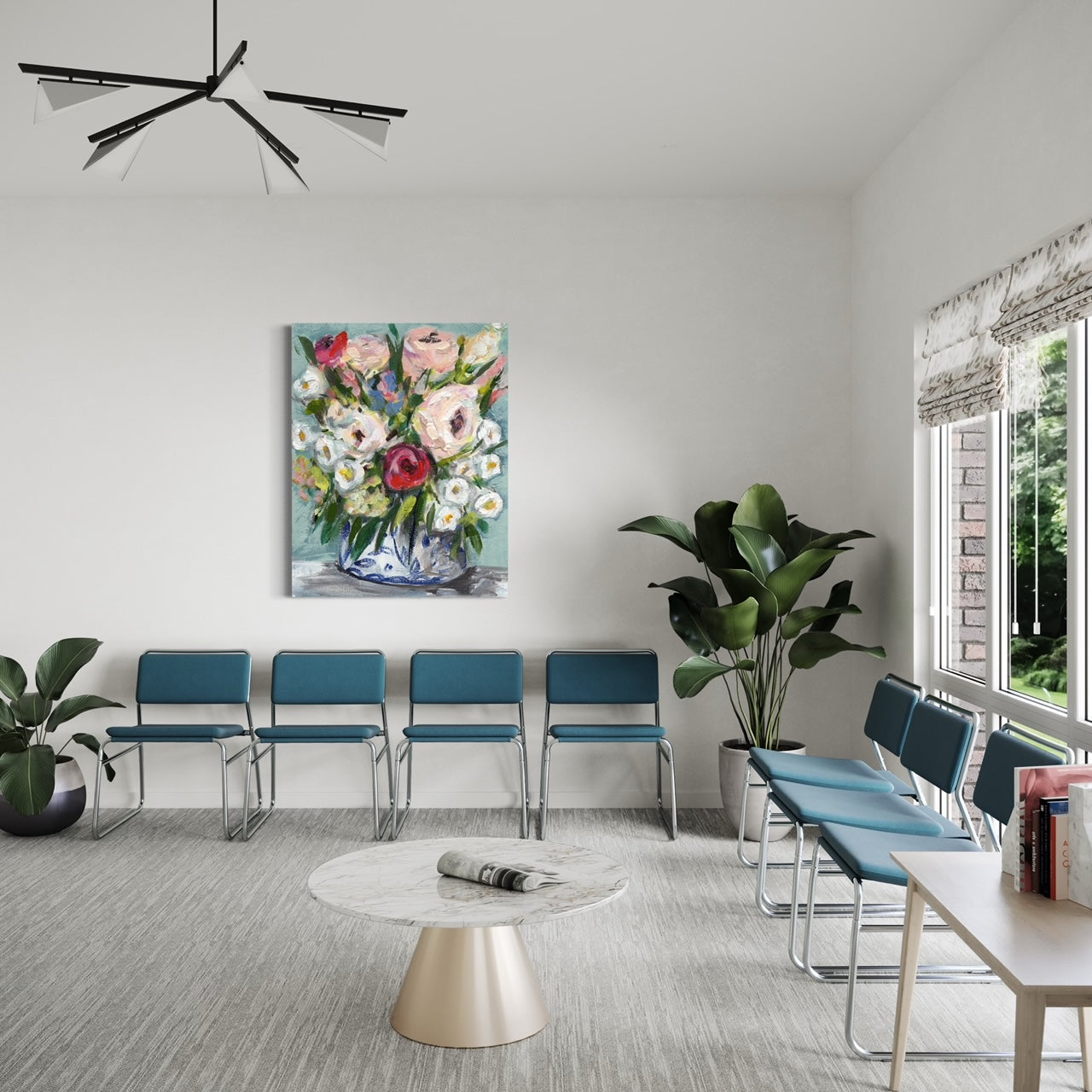 Waiting room with art, chairs, and plants.