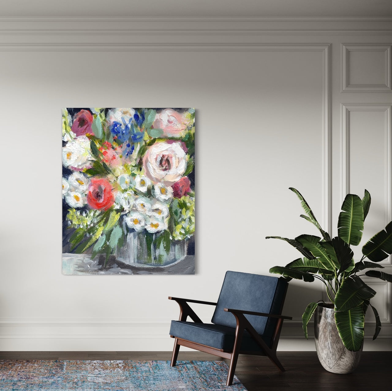 Floral painting above a blue chair and plant.