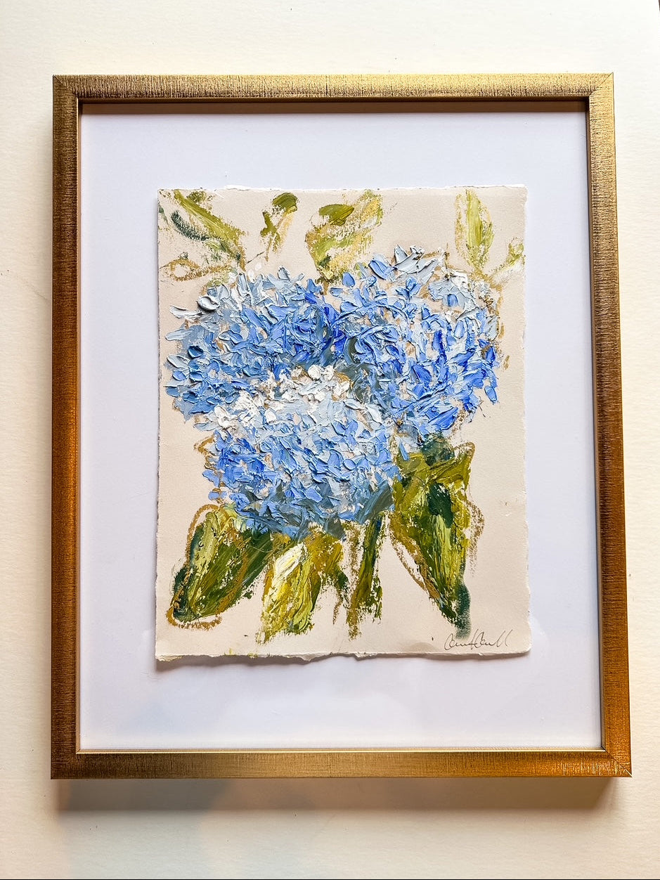 Framed painting of blue flowers on a beige background