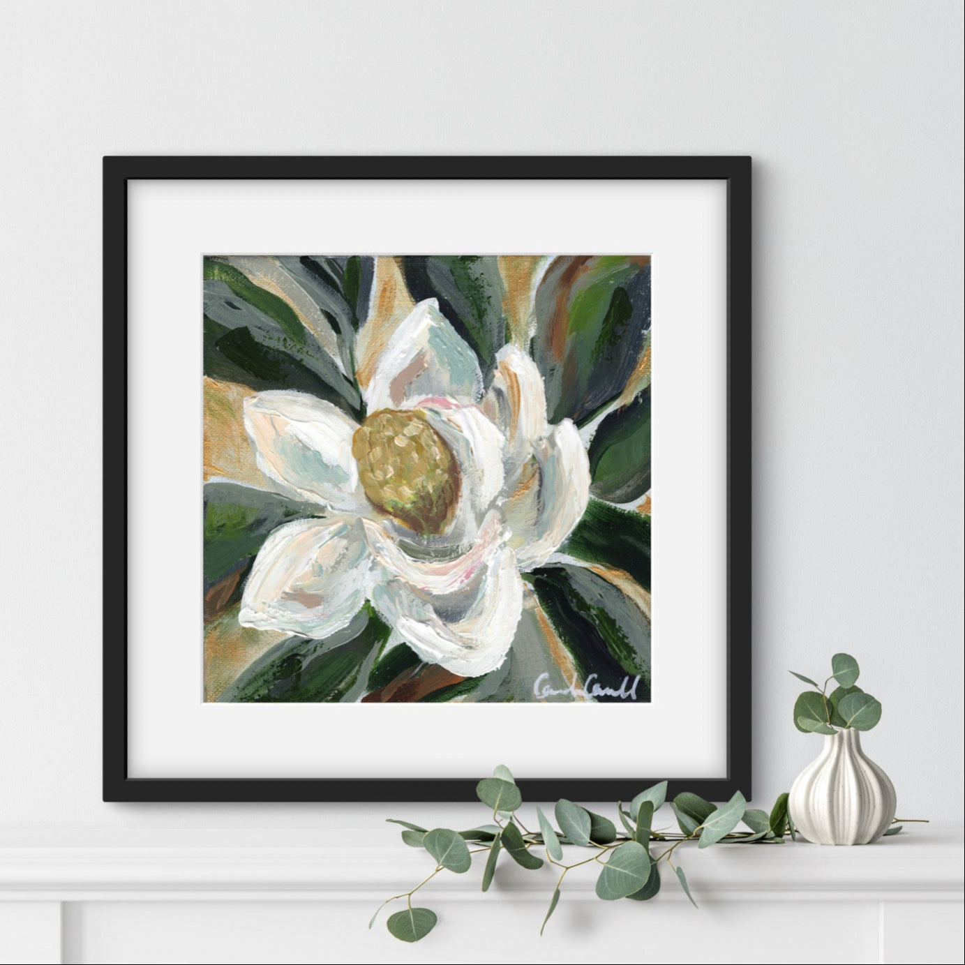 Painting of a white magnolia flower in a black frame.