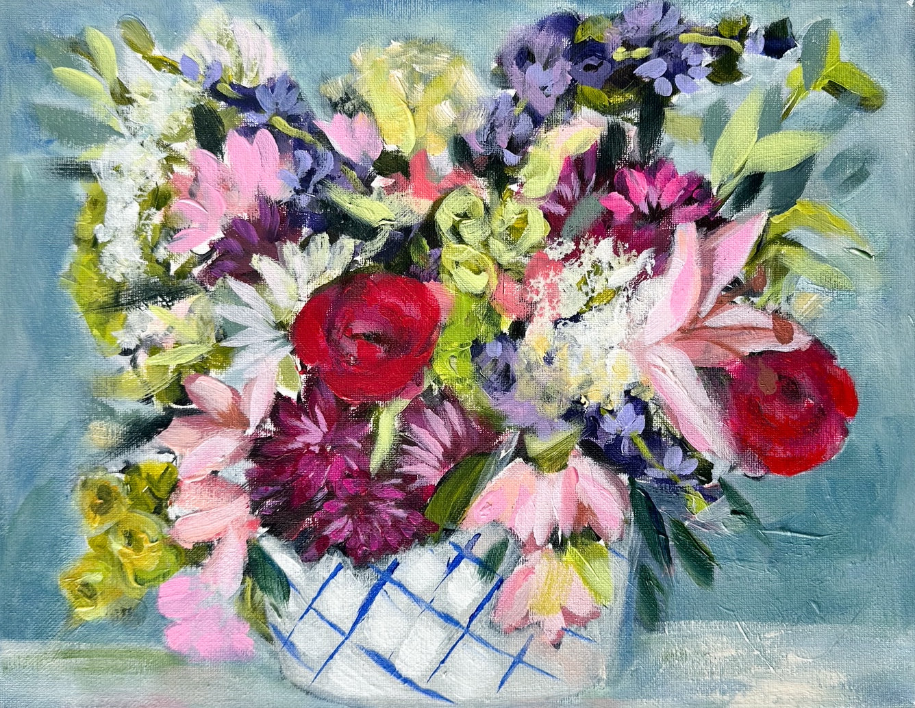Colorful bouquet of flowers in a patterned vase.
