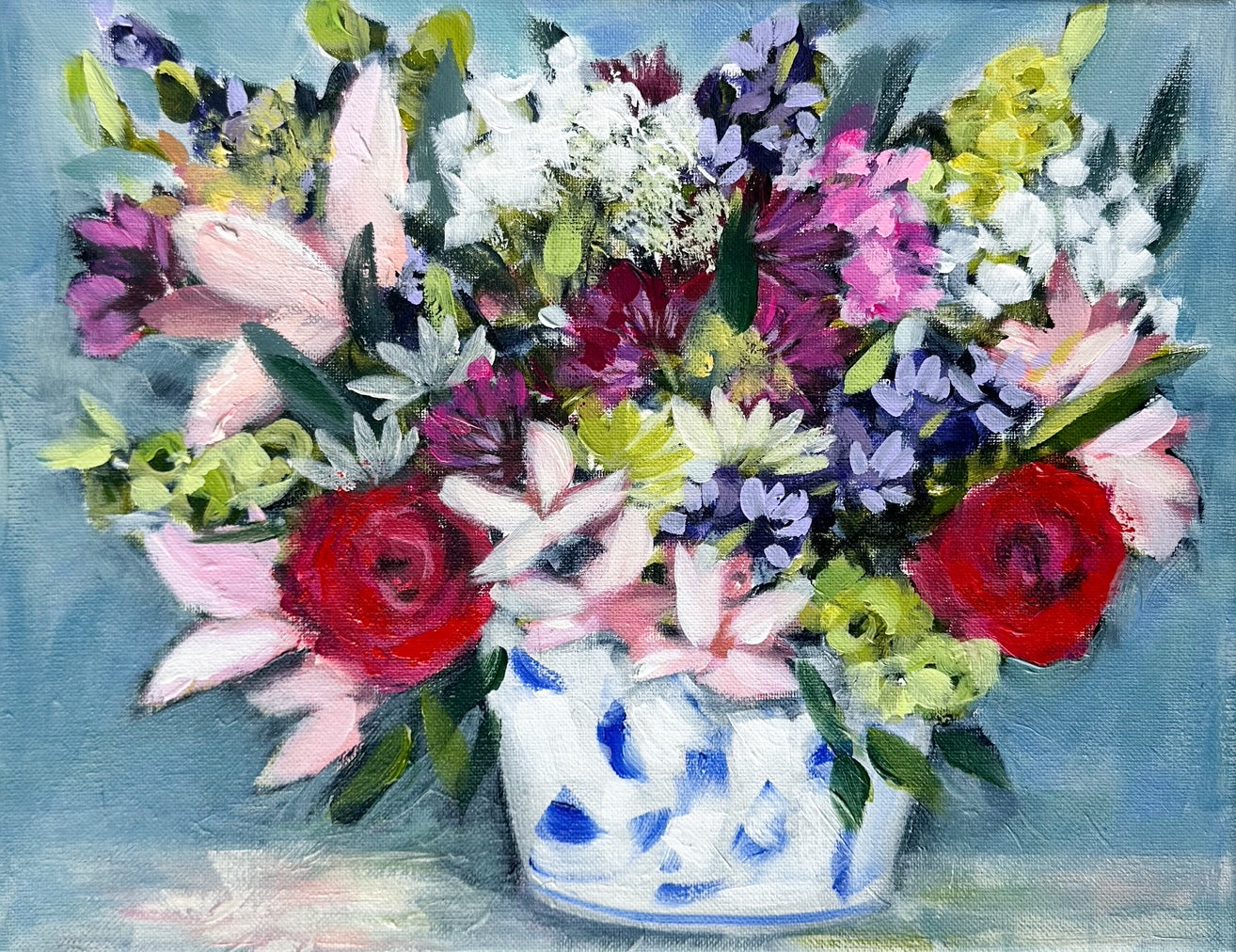 Colorful flowers in a blue and white vase.