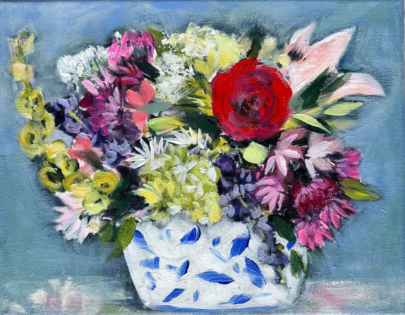 Colorful flowers in a blue and white vase.