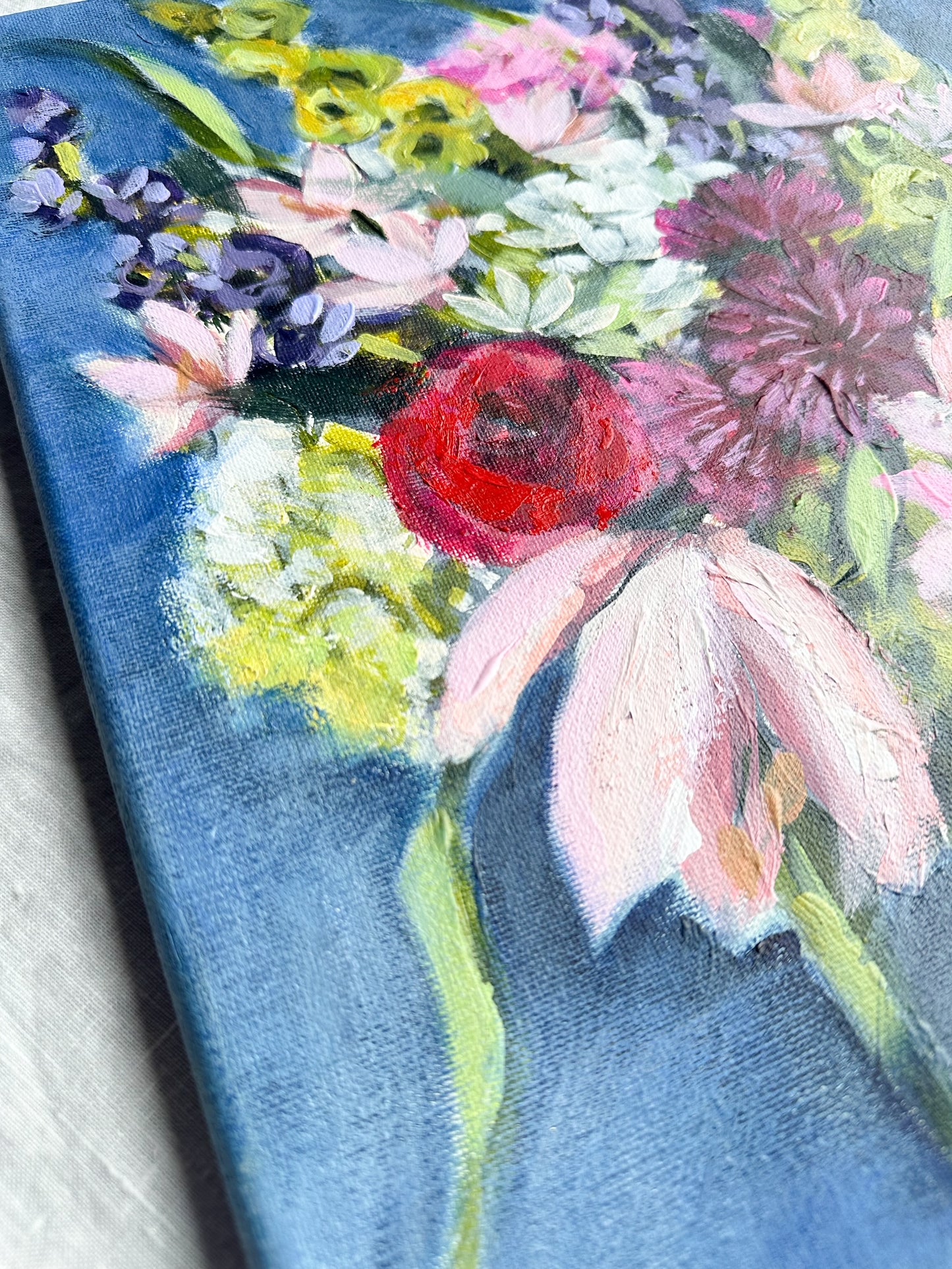 Close-up of a floral painting with various colorful blooms.