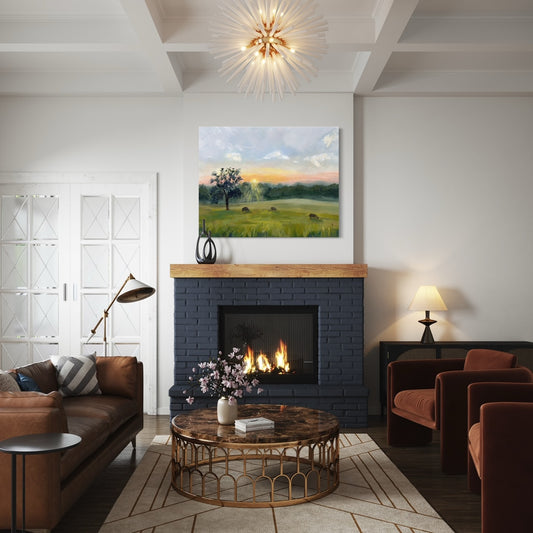 art print of a sunrise over a tranquil field in cozy living room with fire place and warm toned furniture