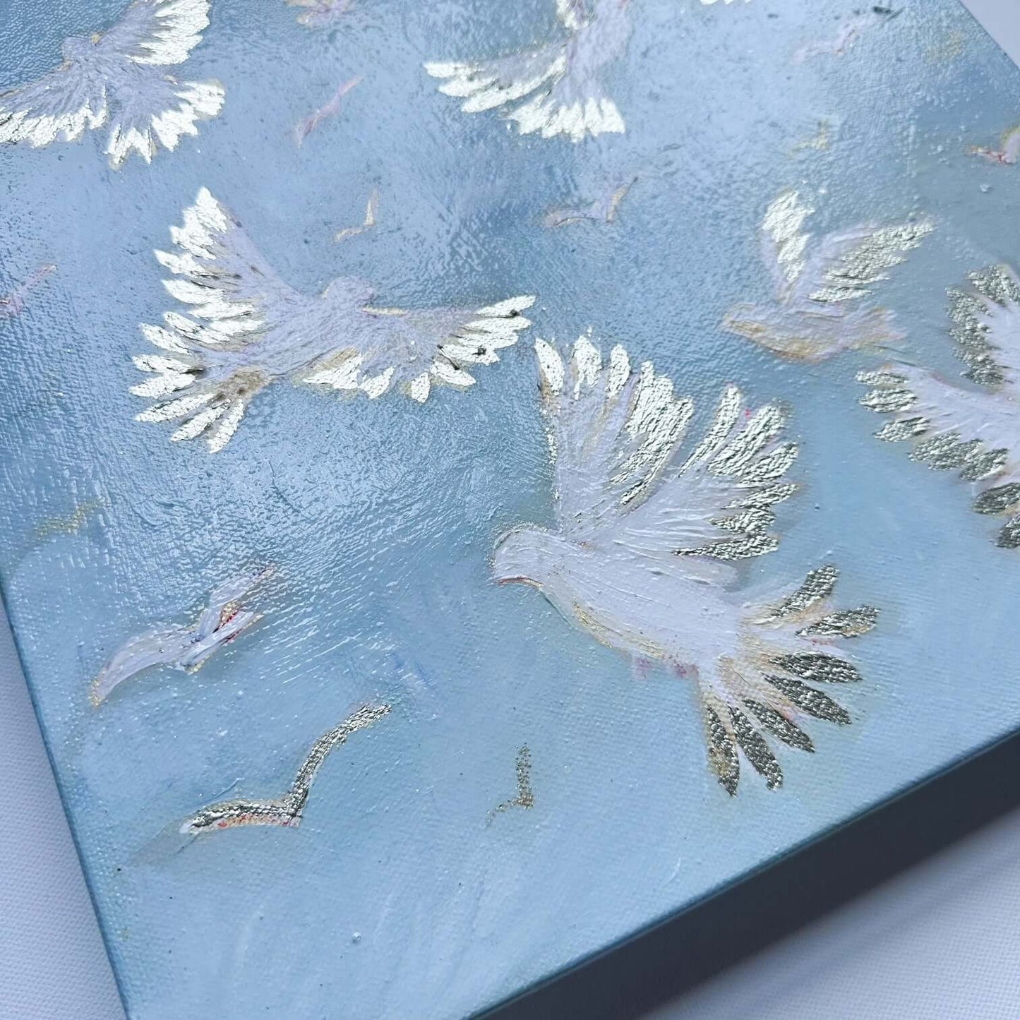 original painting with white birds flying and gold leaf wings