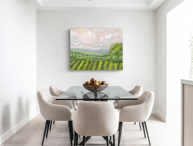Dining room with a glass table and chairs, featuring a painting of a vineyard on the wall.