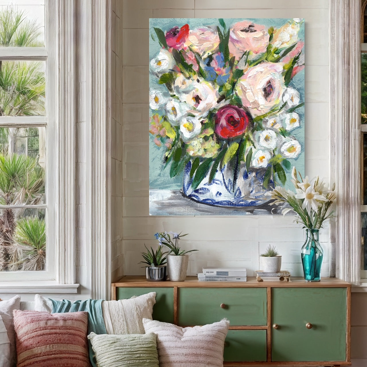 art print of floral bouquet with pink white, red, and blue flowers on aqua blue background in a casual living space