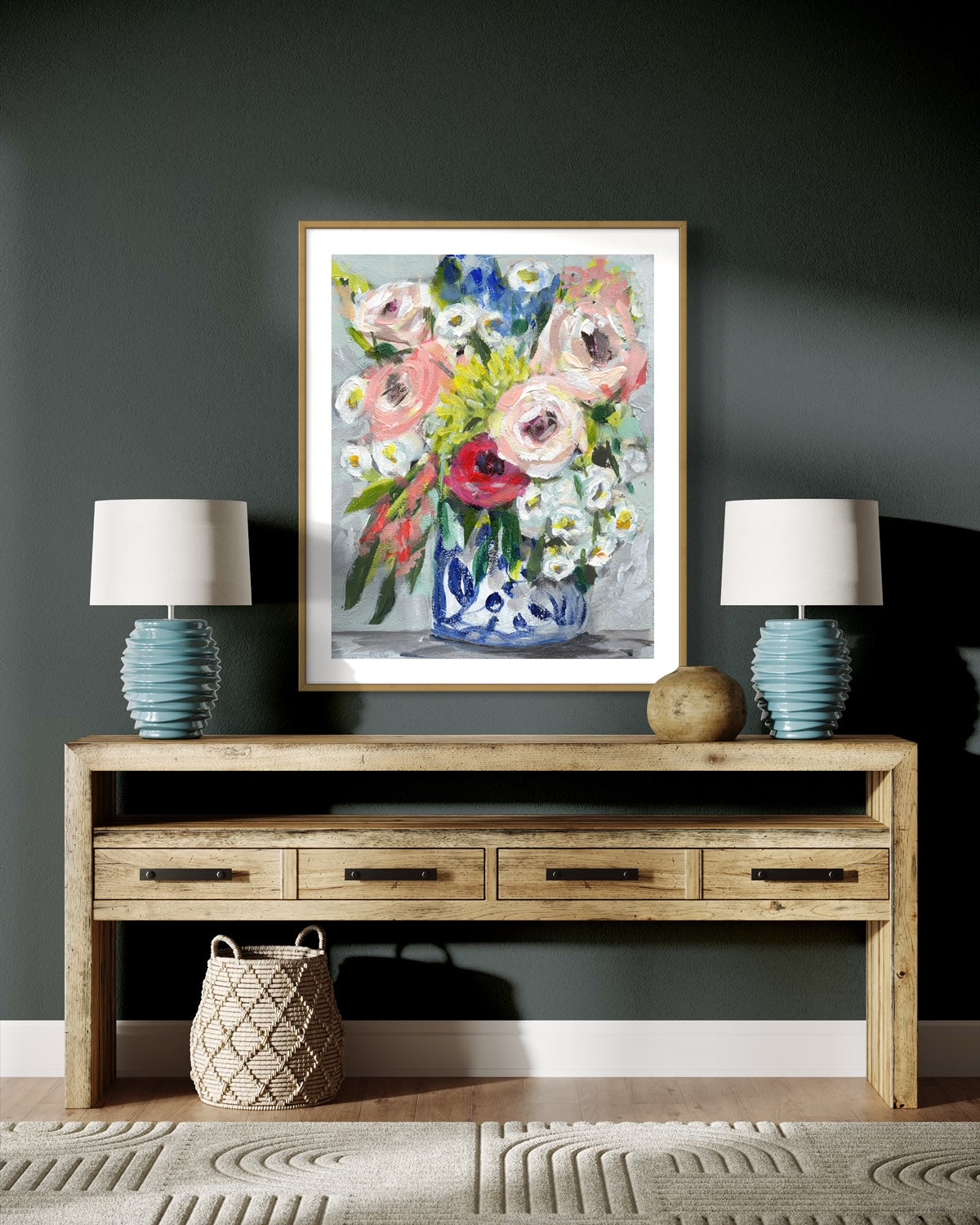 Floral bouquet with colors of pink, red, yellow and white on neutral grey background framed in wood frame on dark grey wall