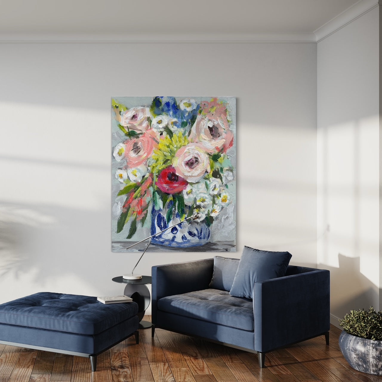 Floral bouquet with colors of pink, red, yellow and white on neutral grey background hung on white wall with blue chair