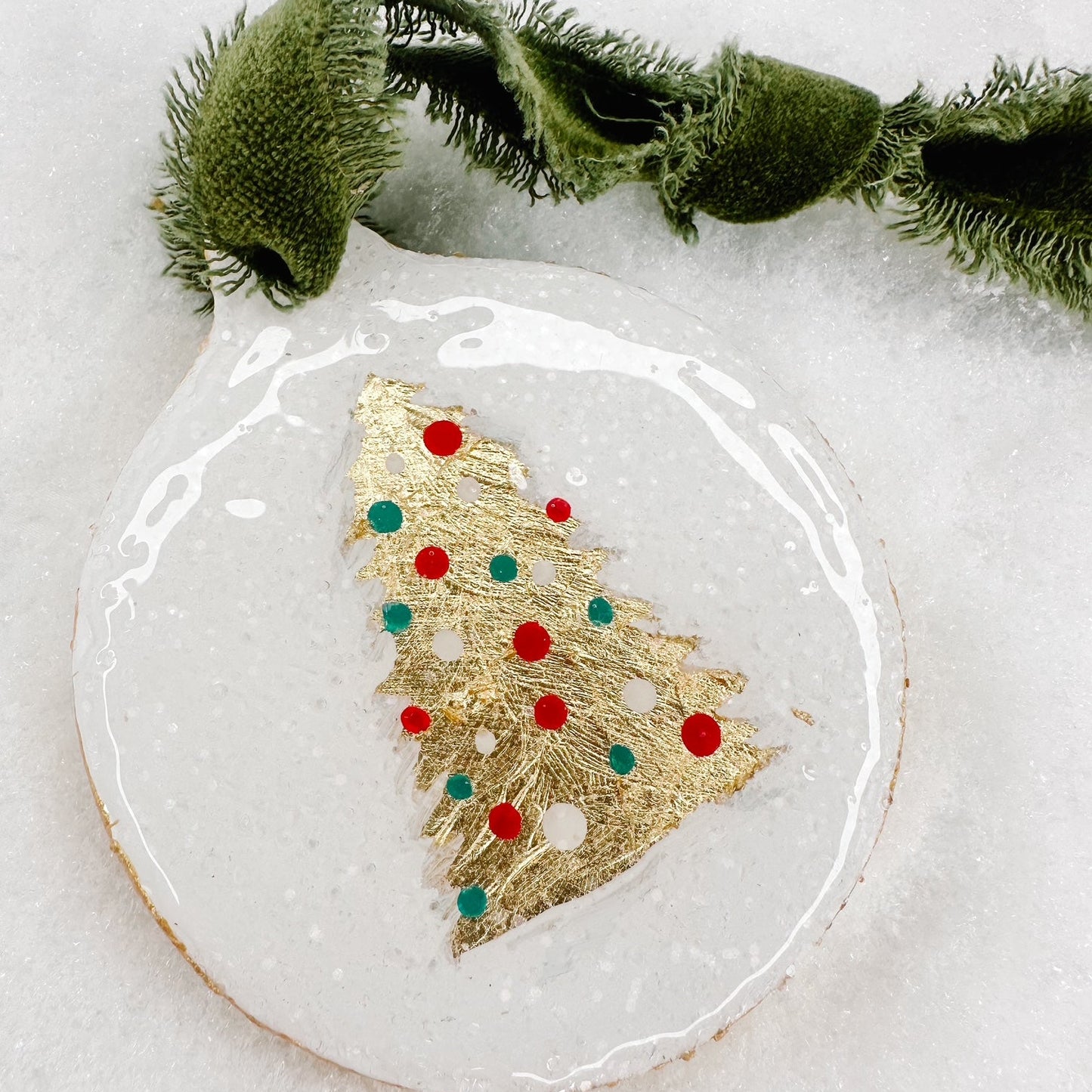 Decorative Christmas ornament with gold tree design on a white background