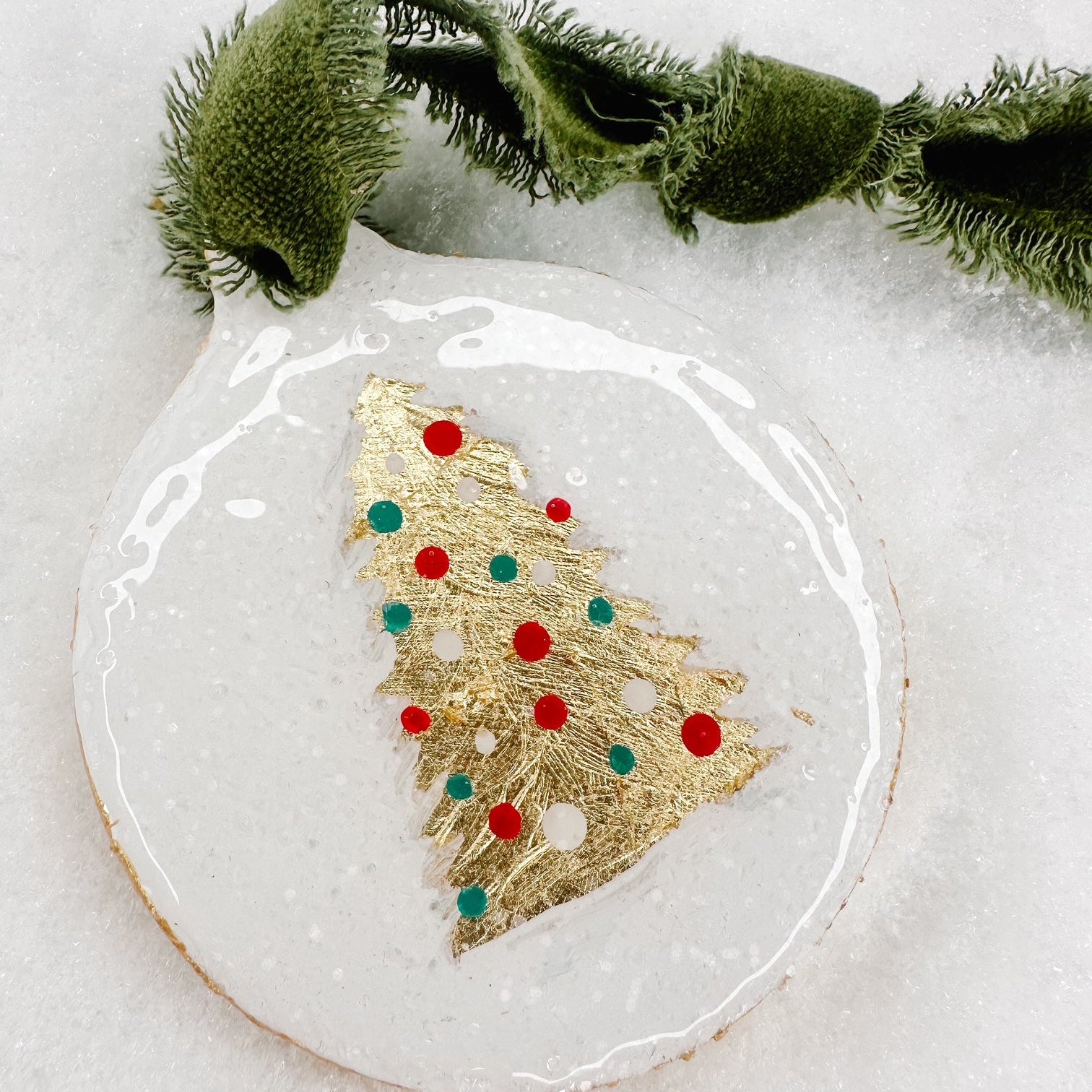Decorative Christmas ornament with gold tree design on a white background