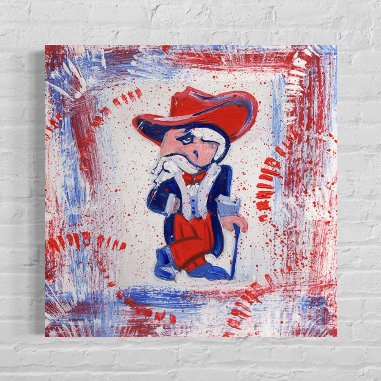 University of Mississippi Mascot Colonel Reb Canvas Print with red and blue background hanging on white painted brick wall.