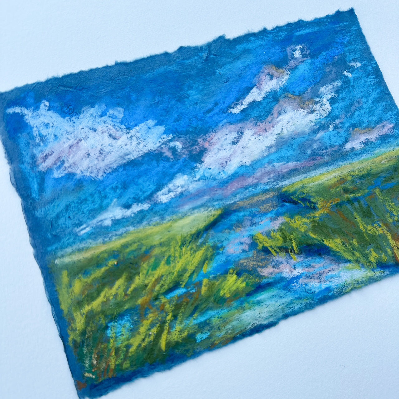 Artistic depiction of a landscape with blue sky and green fields on a textured surface.