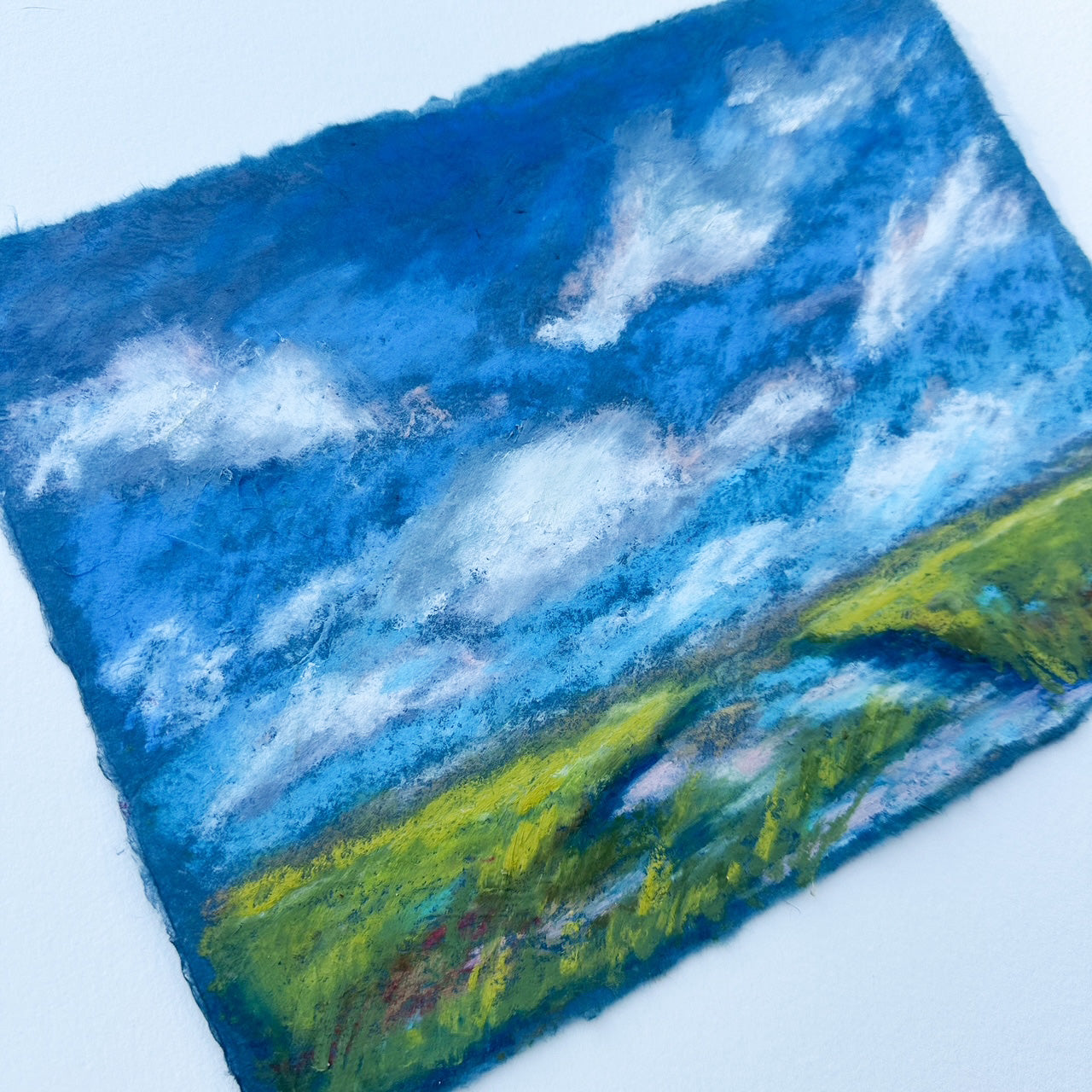 Artistic depiction of a landscape with blue sky and green fields on a textured surface.