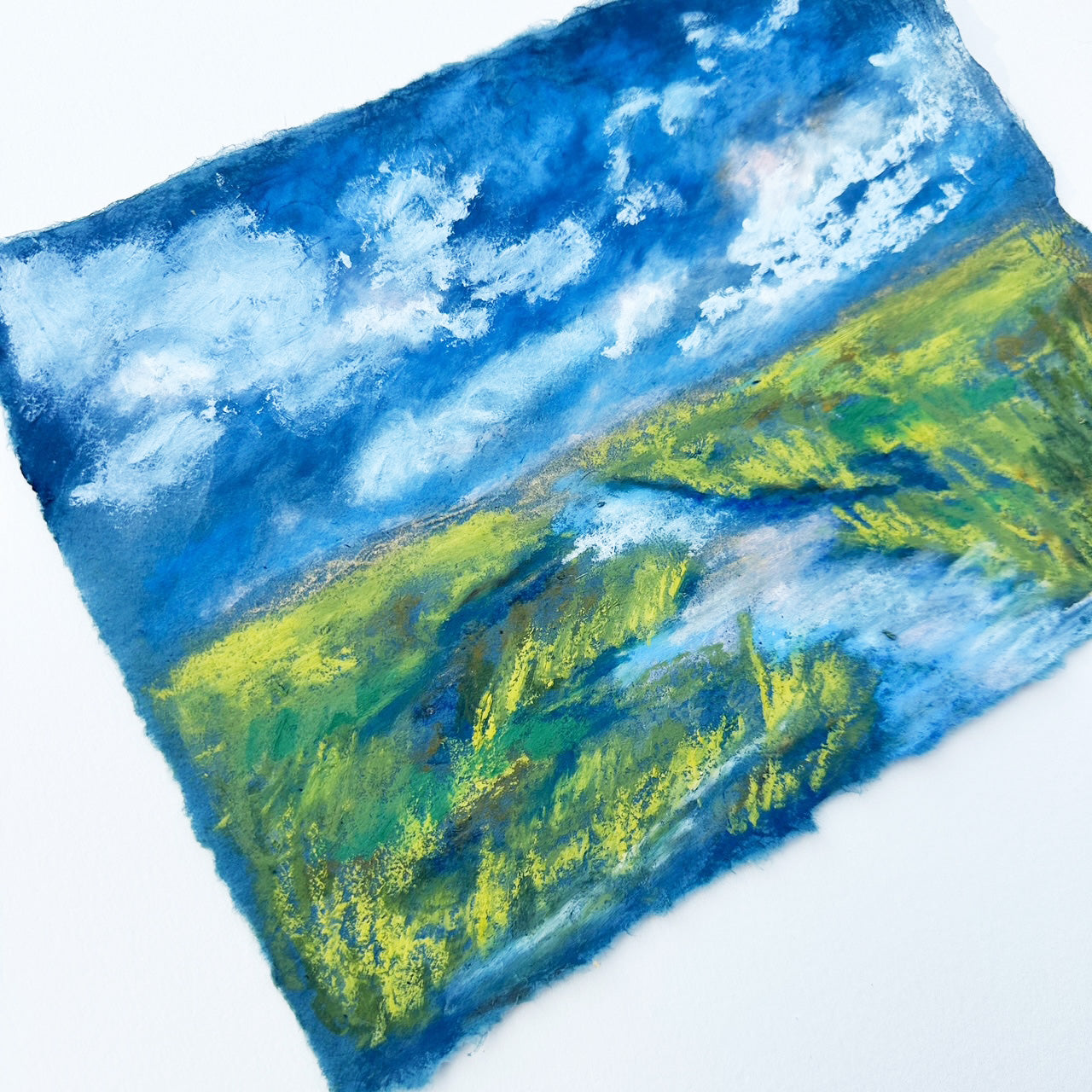 painting of blue sky with white fluffy clouds over marsh