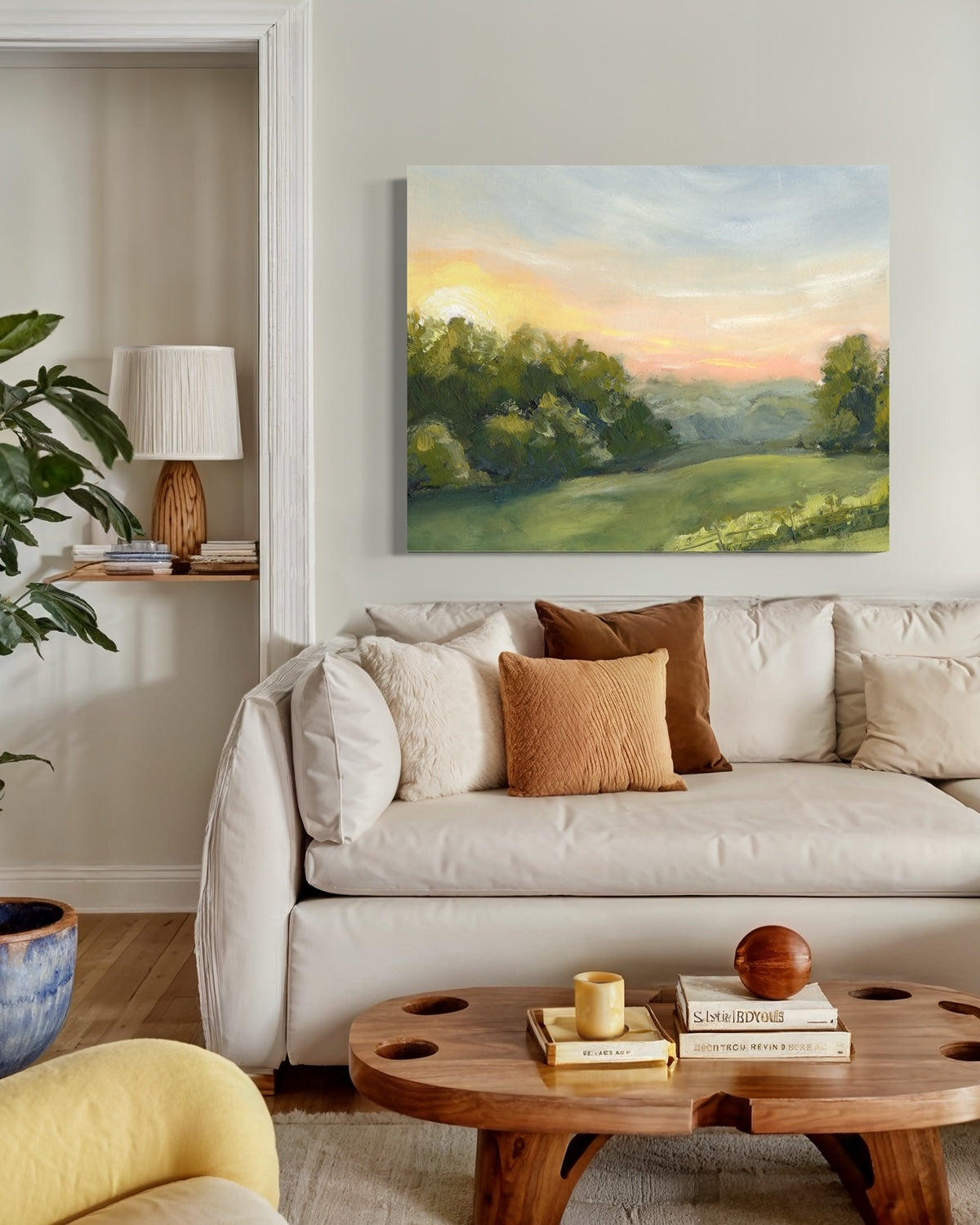 Canvas print of a field at dawn. captures the tranquil beauty of a pink sunrise over an expansive field. in living room with warm tones